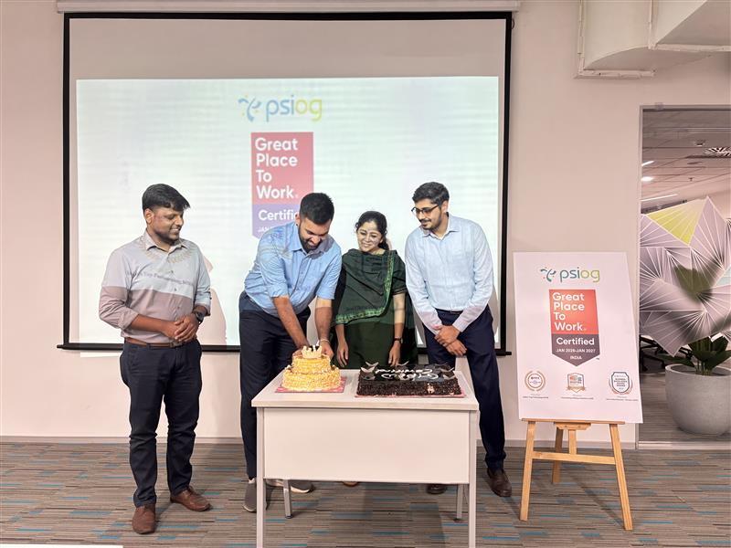 Four people celebrate a Great Place to Work certification with two cakes.